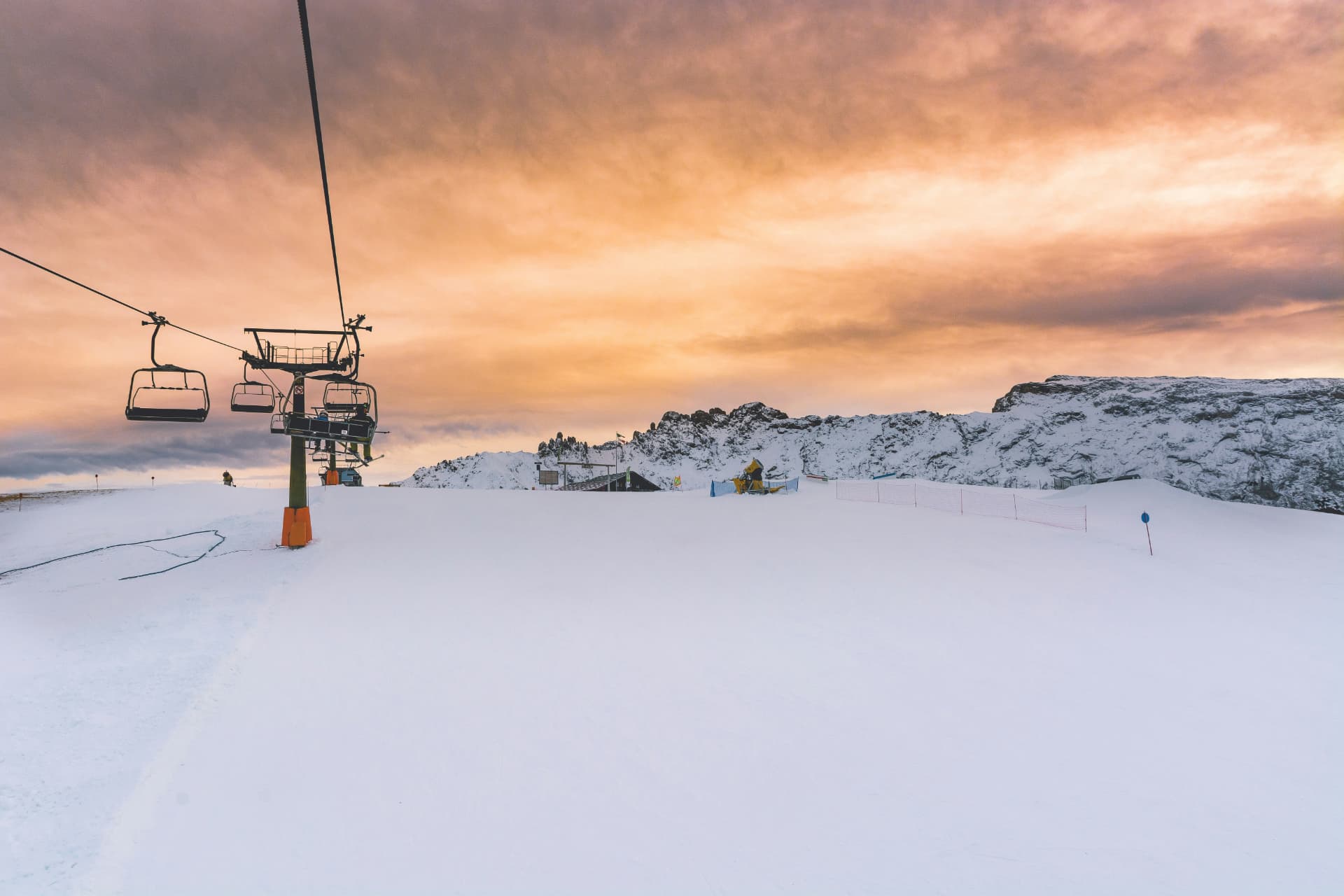 A chairlift over fresh snow at dusk