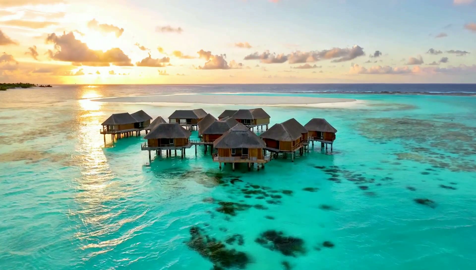 A pale sandbank meeting turquoise water in the Indian Ocean