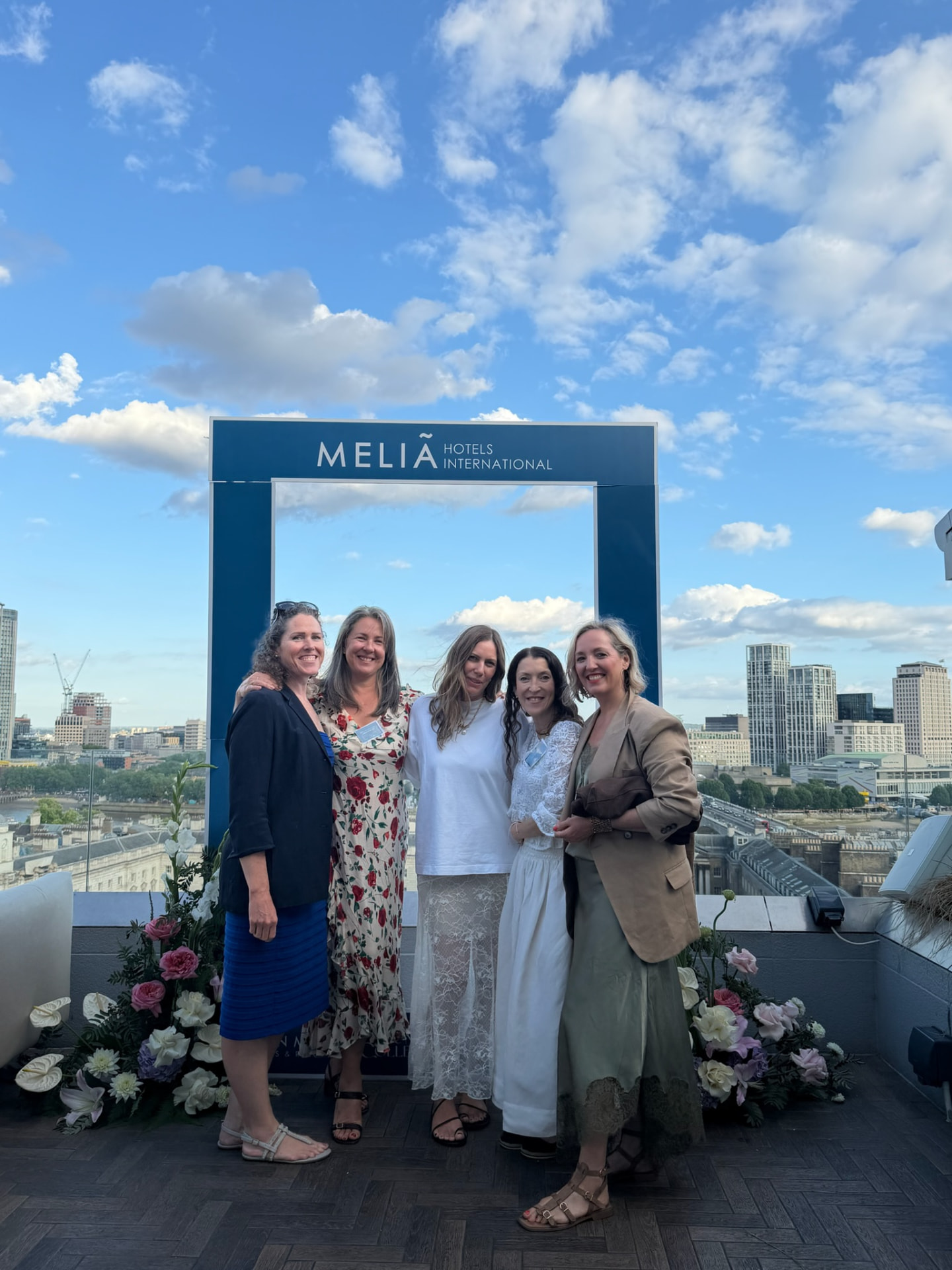 Nadine with travel colleagues at a rooftop event in London